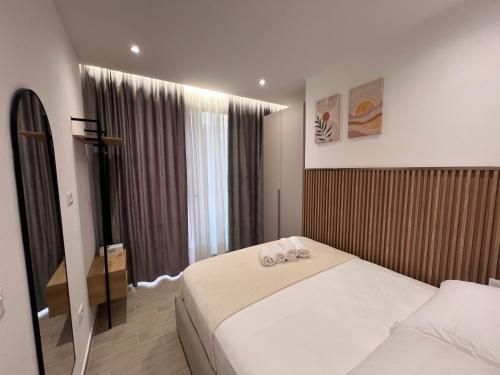 a hotel room with a bed and a window at Palmera Escape Radhime in Vlorë