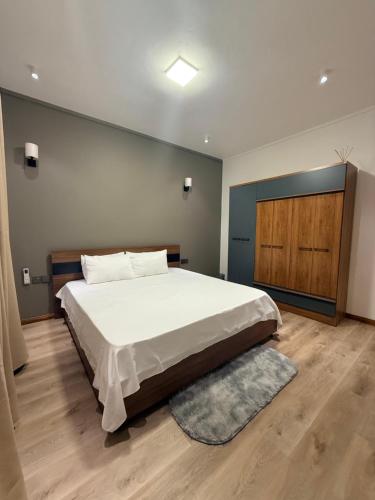a bedroom with a large bed and a wooden floor at VLAP Residence in Baie du Tombeau