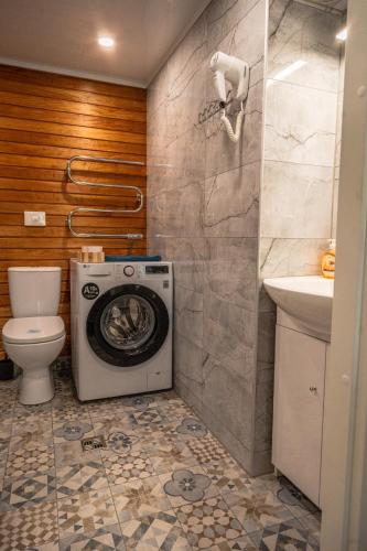a bathroom with a washing machine and a toilet at Ämmamoori Maja - Mother-in-Law's House in Palmse