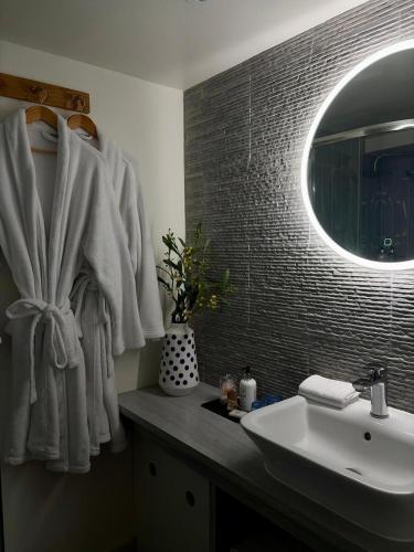 a bathroom with a sink and a mirror at Beach Hut Suites in Bognor Regis