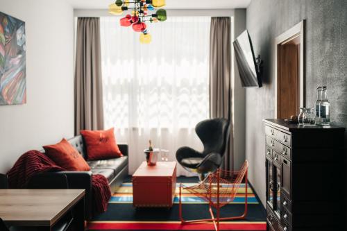 a living room with a couch and a chair at Hotel Polonez in Krakow