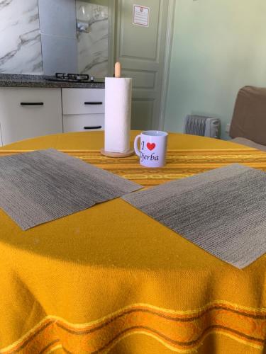 a candle and a cup on a table at Le Typique Djerbien in Houmt Souk