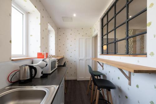 a small kitchen with a sink and a window at Les Brimbelles in Brû