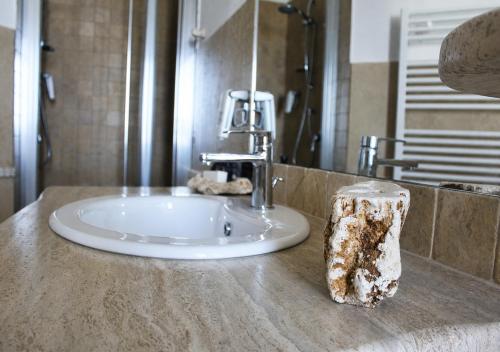 a bathroom counter with a sink in a bathroom at Regia Hotel in Abbasanta