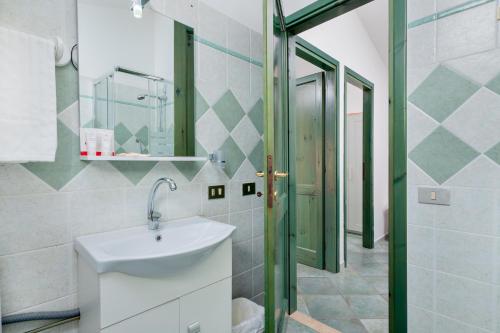a bathroom with a sink and a mirror at Casa Del Marinaio in Cala Gonone