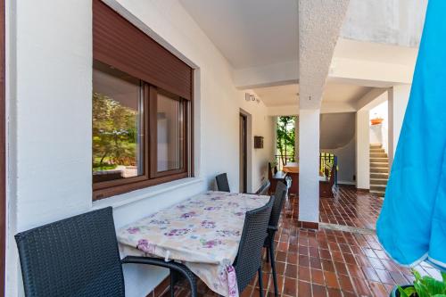 a dining room with a table and chairs at Apartments Villa Ana in Palit