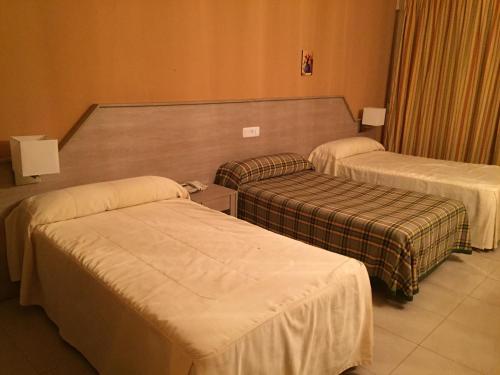 a hotel room with two beds at Hotel Manzanares in Manzanares
