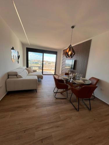 a living room with a couch and a table at Casa Emilia in San Javier