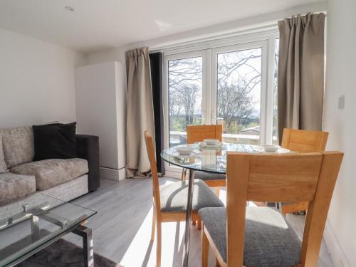 a living room with a table and chairs and a couch at Beacon Fell Cottage 2 in Preston