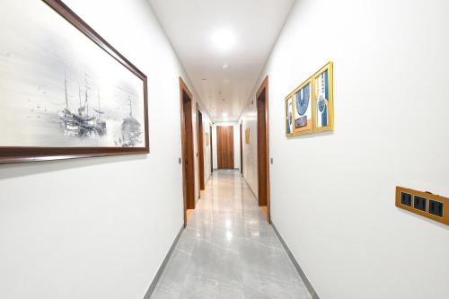 a hallway with paintings on the walls of a house at FabHotel Prime The Ballroom - Near GD Goenka University in Gurgaon