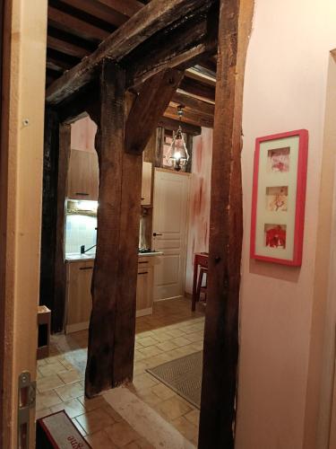 a hallway with wooden beams in a kitchen at La fermette de Vrinette in Saint-Vérain
