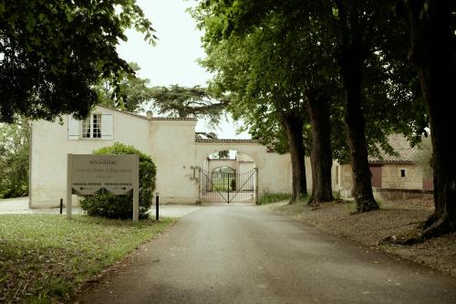 a building with a sign in the middle of a road at Château senailhac in Tresses