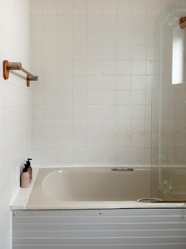 a bath tub with a glass door in a bathroom at Dough Lodge in Lahinch