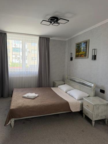a bedroom with a bed and a ceiling fan at Euro Hotel Hostel in Kovel