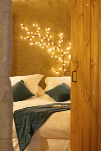 a bedroom with a bed with lights on it at Lantray Secrète in Les-Trois-Moutiers