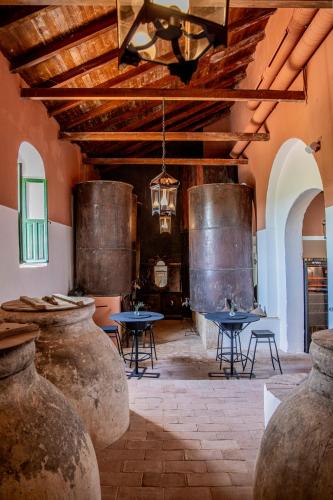a room with two tables and two large vases at Hotel Corbella in Posadas
