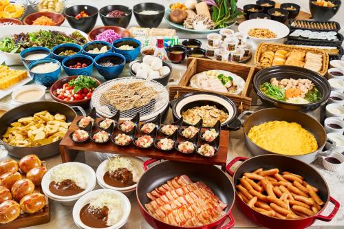 a table topped with lots of different types of food at APA Hotel Komatsu Grand in Komatsu