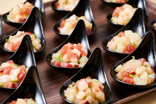 a bunch of small bowls of food on a table at APA Hotel Komatsu Grand in Komatsu