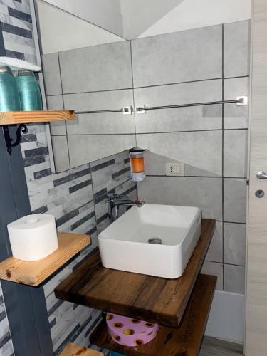 a bathroom with a white sink on a wooden table at Da Michele 2 in Costa Rei