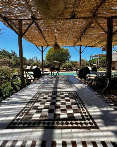 a view of a patio with a table and chairs at Yogam villa Essaouira in Al Ghar