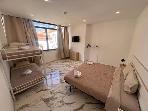 a bedroom with two bunk beds and a large window at The Vault in Portimão