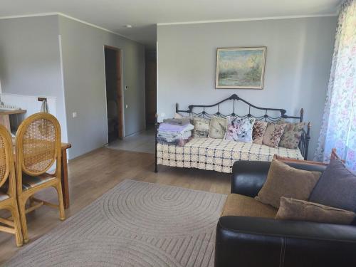 a living room with a couch and a living room with at Vormsi Ohvitseride maja korter nr 6 in Hullo