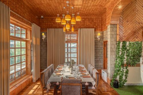 a dining room with a long table and chairs at Padma Villa - Mountain Estate in Manali in Manāli