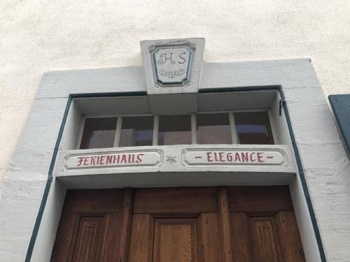 a building with a sign above a door at Altstadtmeise Elegance in Meisenheim