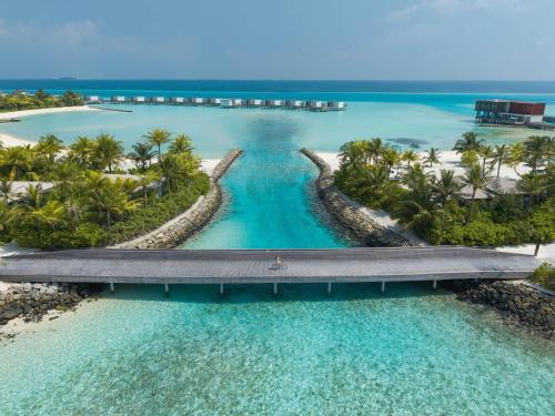 an aerial view of a bridge over the ocean at SO/ Maldives in South Male Atoll