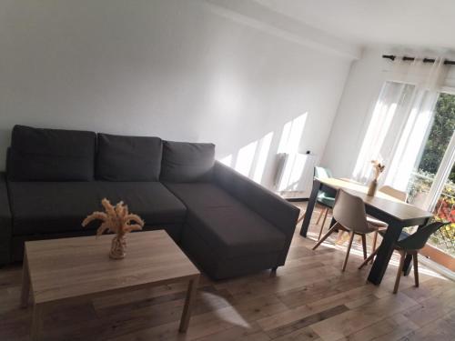 a living room with a couch and a table at JenAlya in Vallauris