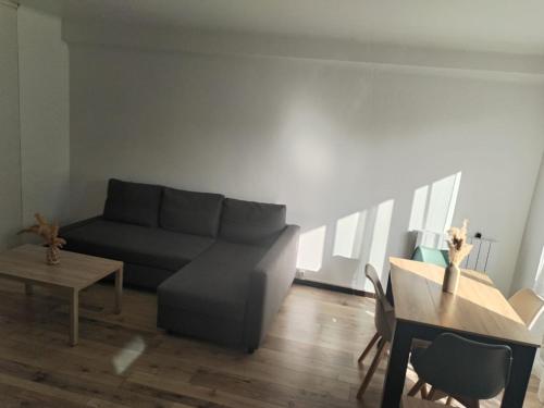 a living room with a couch and a table at JenAlya in Vallauris