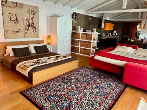 a bedroom with two beds and a rug at Ara Town House in San Giovanni la Punta