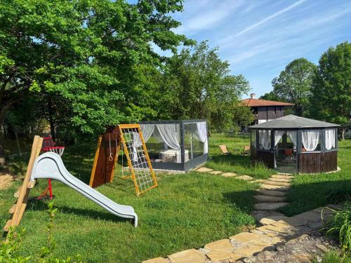 a playground with a slide and a gazebo at Vintage House in Elena