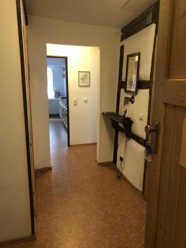 a hallway with a door and a table in a room at Altstadtmeise Rustika in Meisenheim