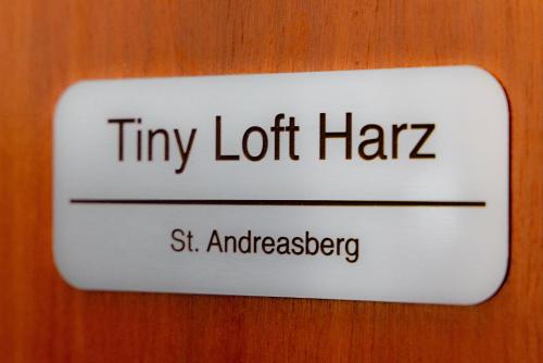 a sign that says tiny lot harz on a door at Tiny Loft Harz in Sankt Andreasberg