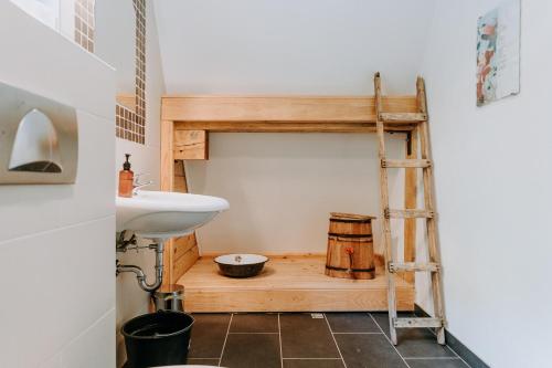 a small bathroom with a sink and a ladder at Herzegovina Lodges Boracko Jezero in Konjic