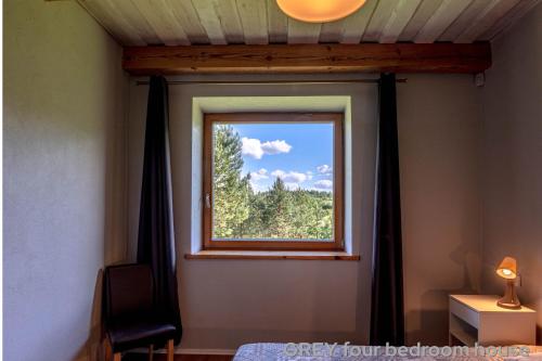 a window in a room with a curtain at Prie Trakų in Petkėniškės