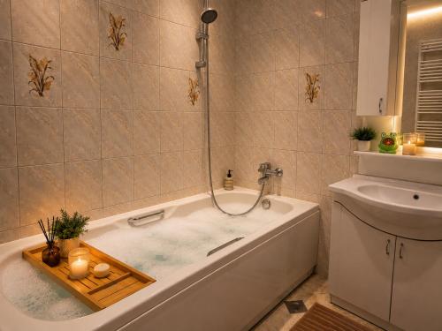 a bathroom with a bath tub and a sink at AS Apartment Tetovo in Tetovo