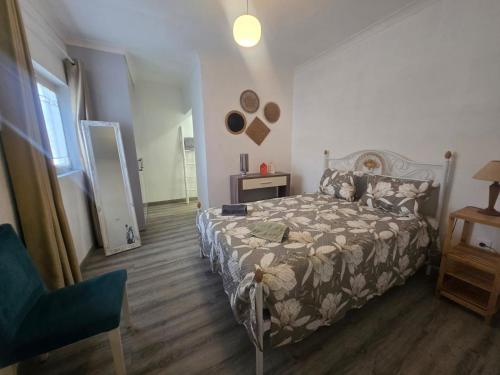 a bedroom with a bed and a table and a chair at Villa Mares in Casas Novas de Marés