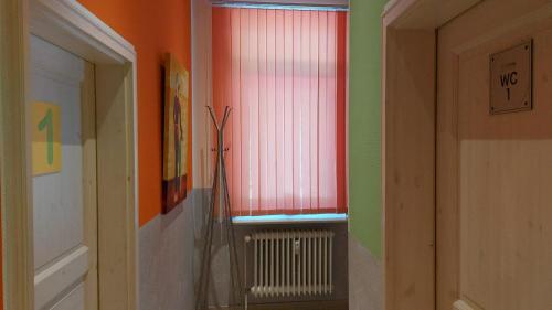 a hallway with a window and a radiator in a room at FineApartment Rendsburg in Rendsburg