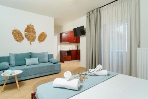 a living room with a blue couch in a room at Porto Nuovo Studio 2 in Limenas
