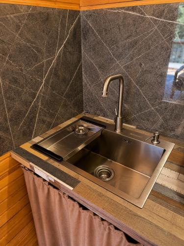 a stainless steel sink in a kitchen at Kolsay Tanbalytas A-Frame in Kolʼbastau