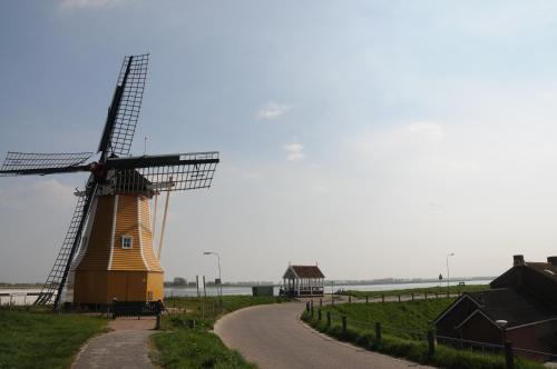 a windmill on the side of a road at Residentie Oosterschelde in Sint Philipsland