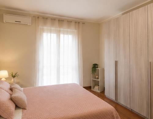 a bedroom with a bed and a large window at In Piazza Pompeii in Pompei