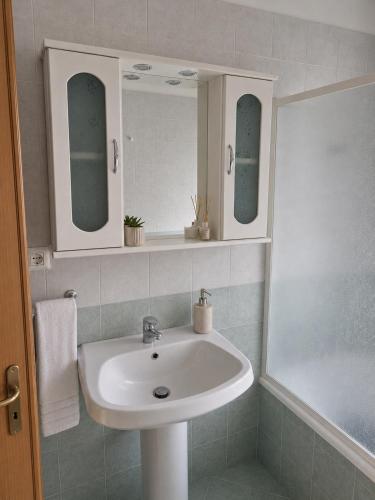 a bathroom with a sink and two mirrors at In Piazza Pompeii in Pompei