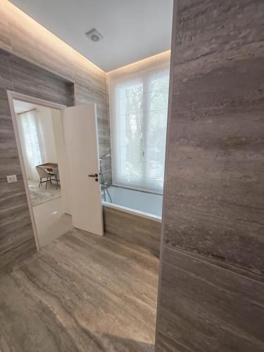 an empty room with a door and a window at La Maison Cannoise in Cannes