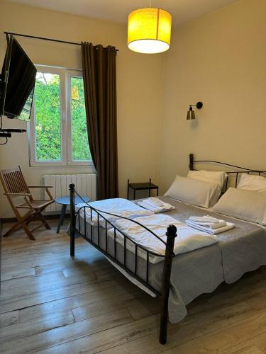 a bedroom with a bed and a table and a window at Dvali in Tbilisi City