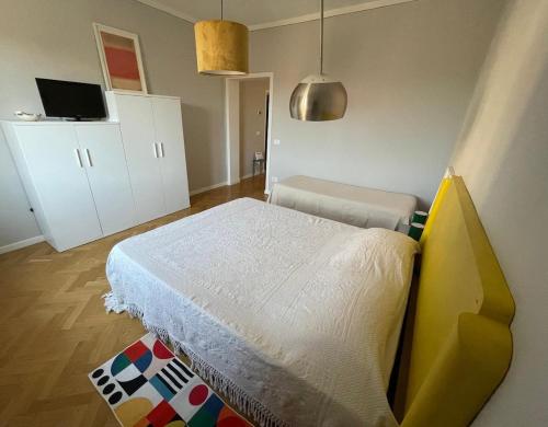 a bedroom with a bed and a white cabinet at Appartamento ai piedi del Borgo in Certaldo
