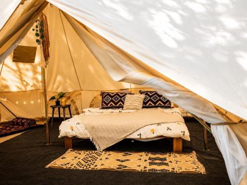 a tent with a bed in the middle at Glamping Hive in Čmeliny