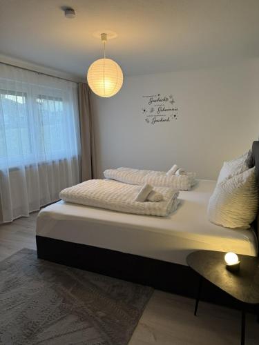 a bedroom with a bed with two pillows on it at Manni's Home in Munderkingen
